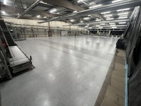 a large warehouse with a large concrete floor